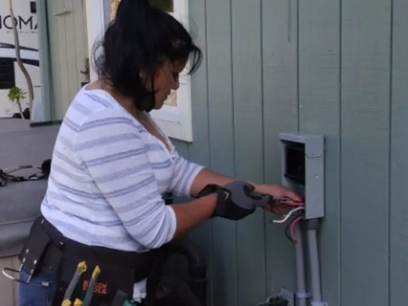 Licensed electrician wiring an exterior subpanel in Navasota