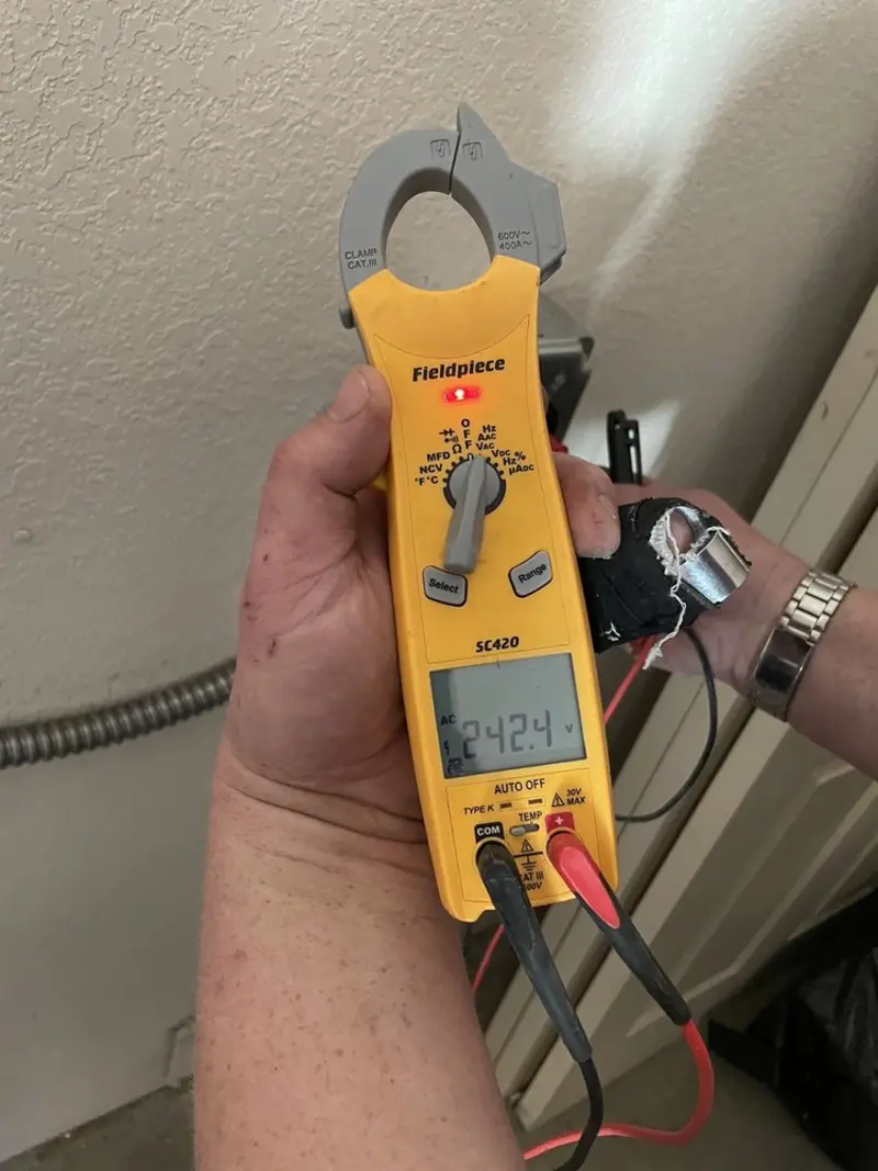 Voltage testing with clamp meter during Recessed Lighting Installation in Navasota